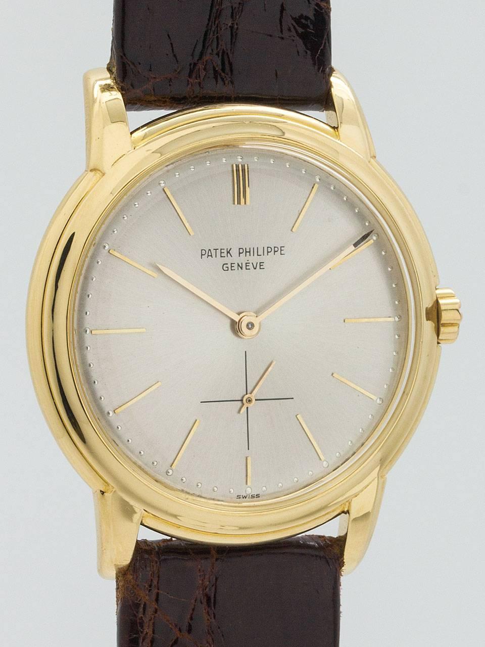 Patek Philippe 18K Yellow Gold Dress Wristwatch ref 3433 circa 1960. Great looking vintage model with stepped 37 x 42.5mm water proof style screw back case. Original matte silvered dial with applied slim indexes and hands, signed Patek Philippe