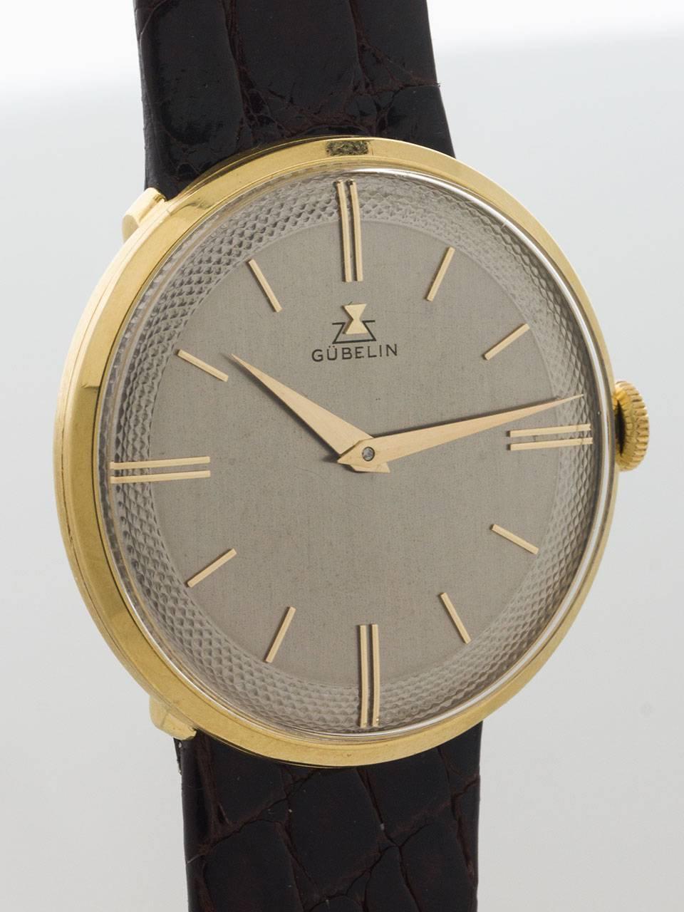 Gubelin 18K Yellow Gold thin and elegant Dress Model circa 1960s. Featuring beautiful condition 34mm diameter case with recessed lugs and low dome crystal. Beautiful original greyed silvered dial with perimeter textured pattern, with applied subtle