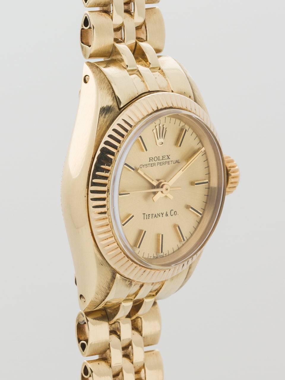Rolex Lady's 14K Yellow Gold Oyster Perpetual ref 6700 serial number 964,xxx circa 1963. 27mm diameter Oyster case with finely milled bezel and acrylic crystal. Original champagne dial, applied indexes and hands, signed Tiffany & Co. With 14K yellow