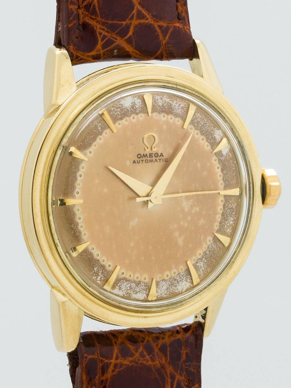Omega 14K Yellow Gold Patina'd Automatic Wristwatch ref 2736 SC circa 1952. Featuring robust 34 X 39mm case with screw down case back with acrylic crystal and signed Omega crown. Original 2 tone richly patina’d dial with applied gold tapered