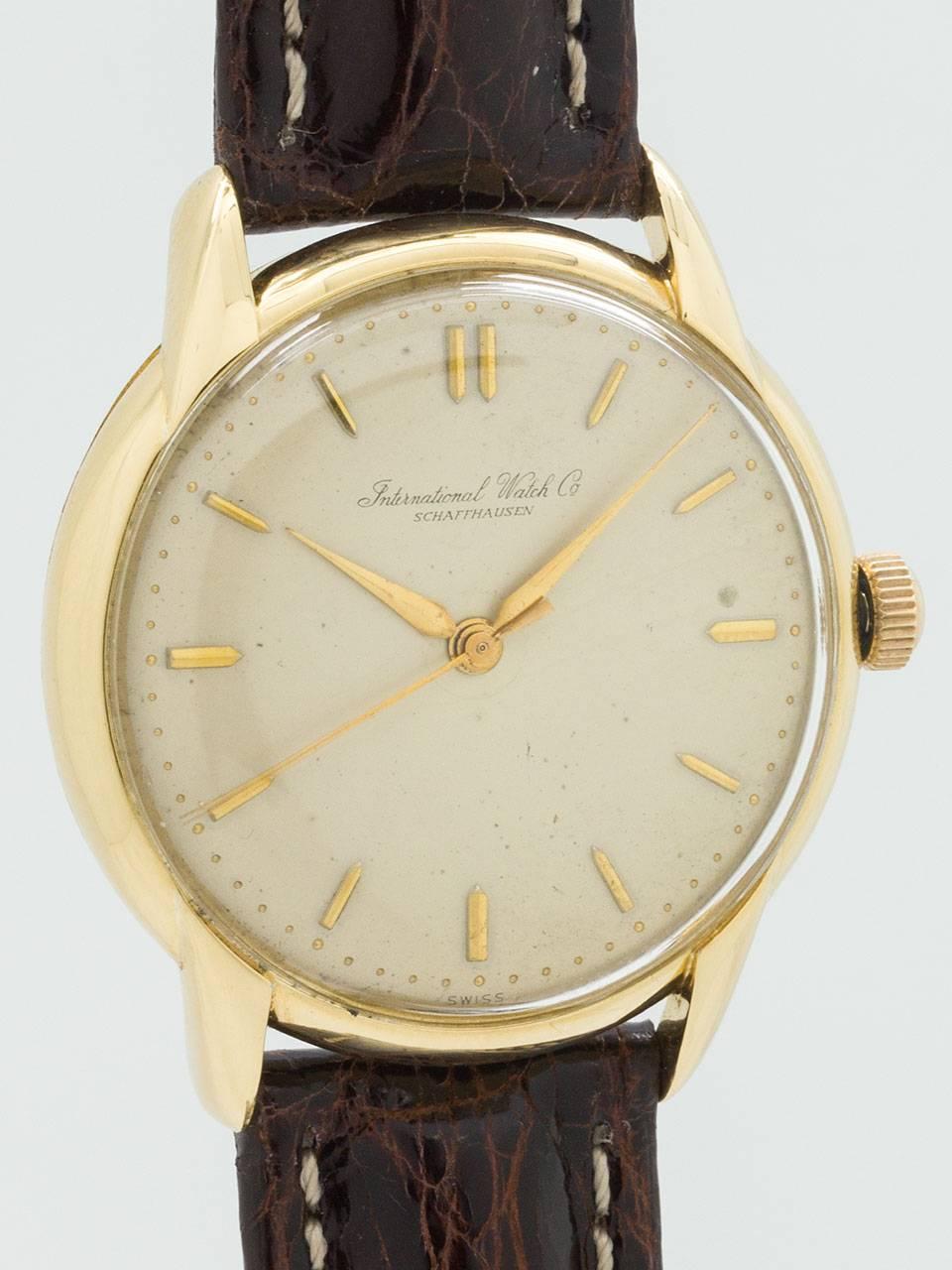 International Watch Co 18K Yellow Gold Dress Model circa 1950s. Featuring 35 x 40mm heavy snap back case with extended horn lugs and acrylic crystal. Original lightly patina’d matte silvered dial with raised gold indexes and tapered elongated hands.