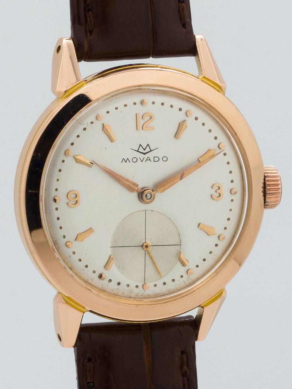 Movado 18K Rose Gold Dress Wristwatch circa 1950s. Featuring 34.5mm diameter case with wide bezel, extended horn lugs, and screw down water proof style case back. With acrylic crystal and original silvered satin dial with rose gold applied indexes,