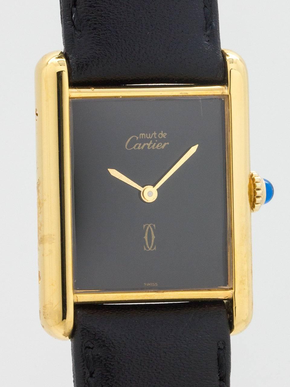 Cartier Man's Vermeil Tank Louis Must de Cartier, circa 1980s. Vermeil, 20 microns gold over silver, 23.5 X 31mm case secured by four screws. Classic black dial signed Must de Cartier and double C logo. Clean dial without indexes, only tapered gold