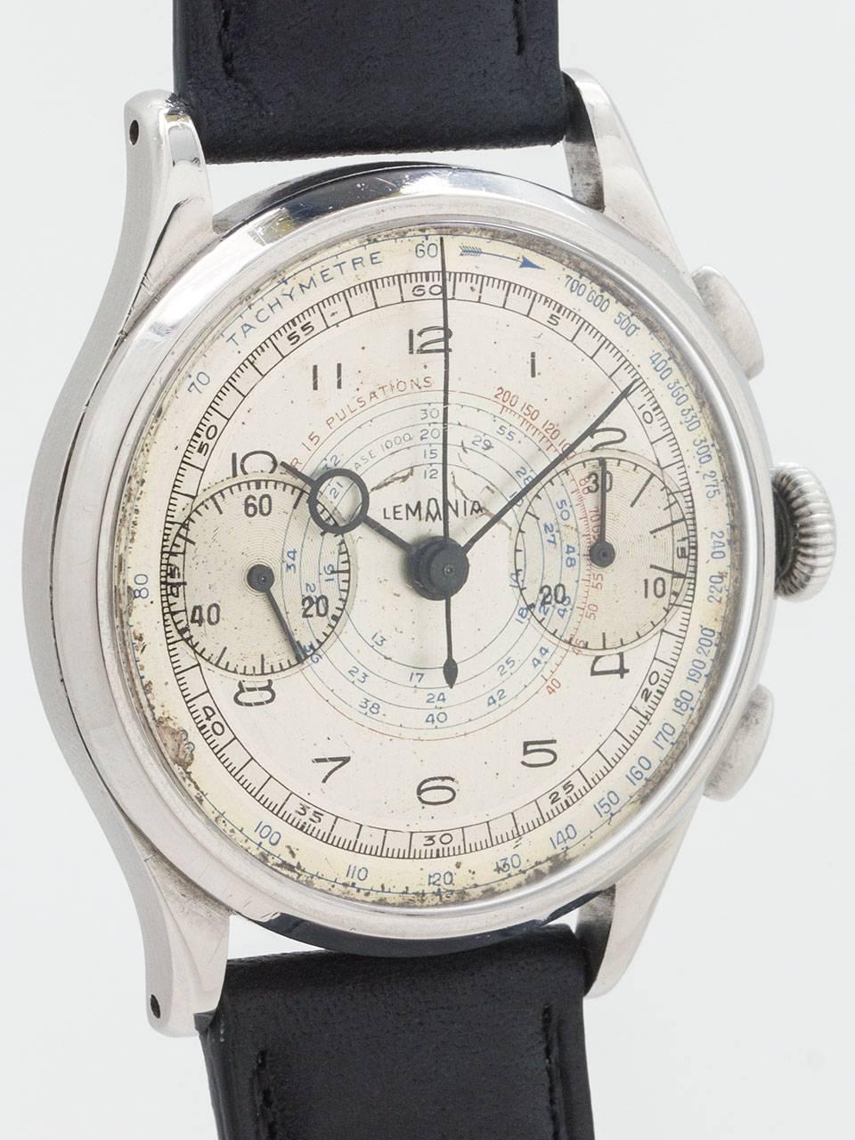 Vintage Lemania Chronograph Wristwatch circa late 1930s. 37mm diameter stainless steel case with onion crown and olive shaped pushers. Dial features an inner tachymeter and telemeter track, as well as a pulsations indicator in red and blue. Aged