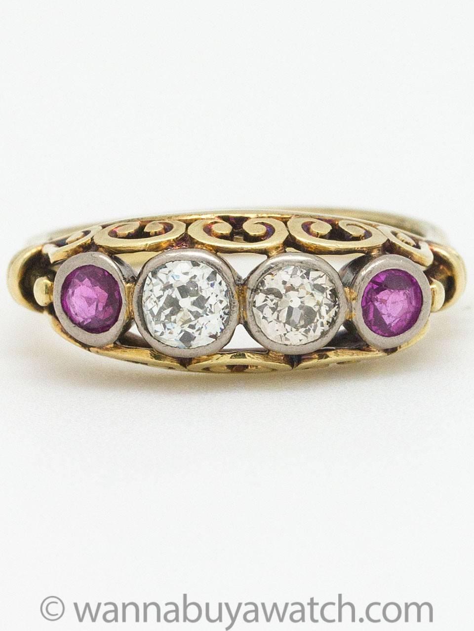 Gorgeous 14k yellow gold antique ruby diamond ring with two Old European cut diamonds and two rubies. Lovely swirl side motif with bezel set stones and lovely patina. Diamond total weight is approximately .75ct, SI-I3 clarity, H-M color. Ruby total