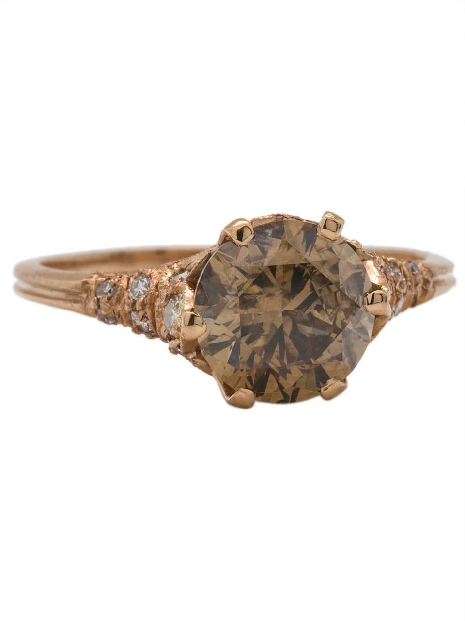 This luscious 18k Rose gold pave diamond ring is set with a stunning 1.85ct Cognac brown round brilliant center diamond, I2 clarity. Sixteen stunningly bright pave-set full cut white side diamonds encompass the sides and shank of this gorgeous