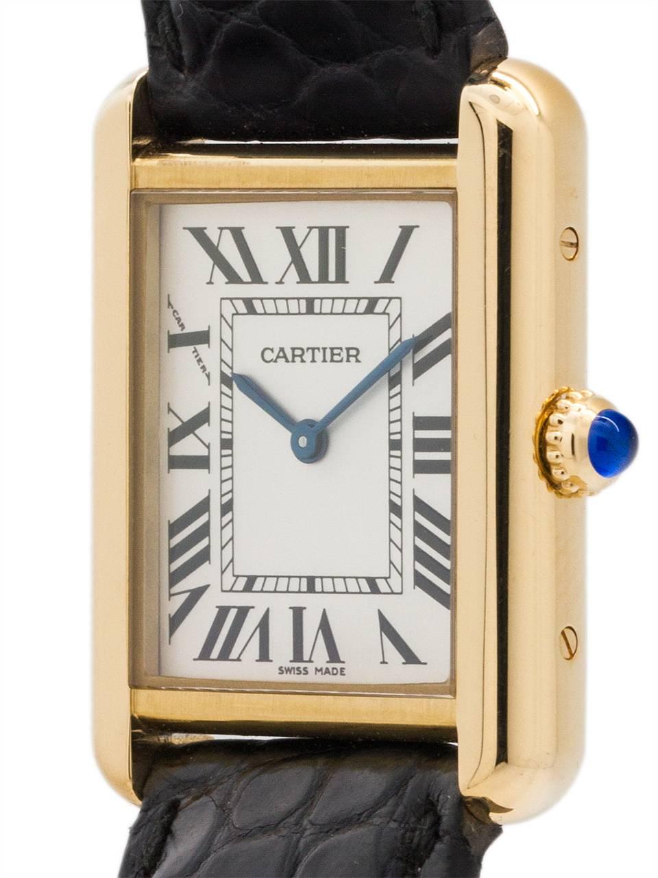 
Lady’s midsize Cartier 18K YG Tank Solo ref 2743, solid 18K YG gold top and stainless steel back secured by 4 side and 4 case back screws. Featuring 24 X 31mm case with scratch resistant sapphire crystal, cabochon sapphire crown, and silver opaline