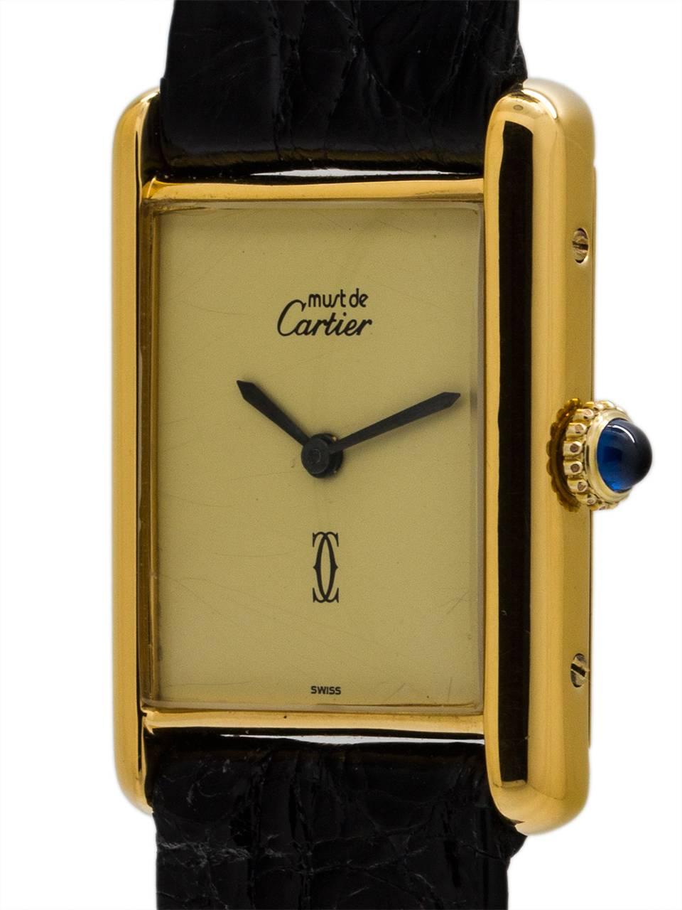 
Cartier Man’s Tank Louis vermeil circa 1970s. 23.5 x 31mm case with mineral glass crystal and blue cabachon sapphire crown. With original cream color dial signed Must de Cartier with double C logo and gold hands. Powered by manual wind movement.