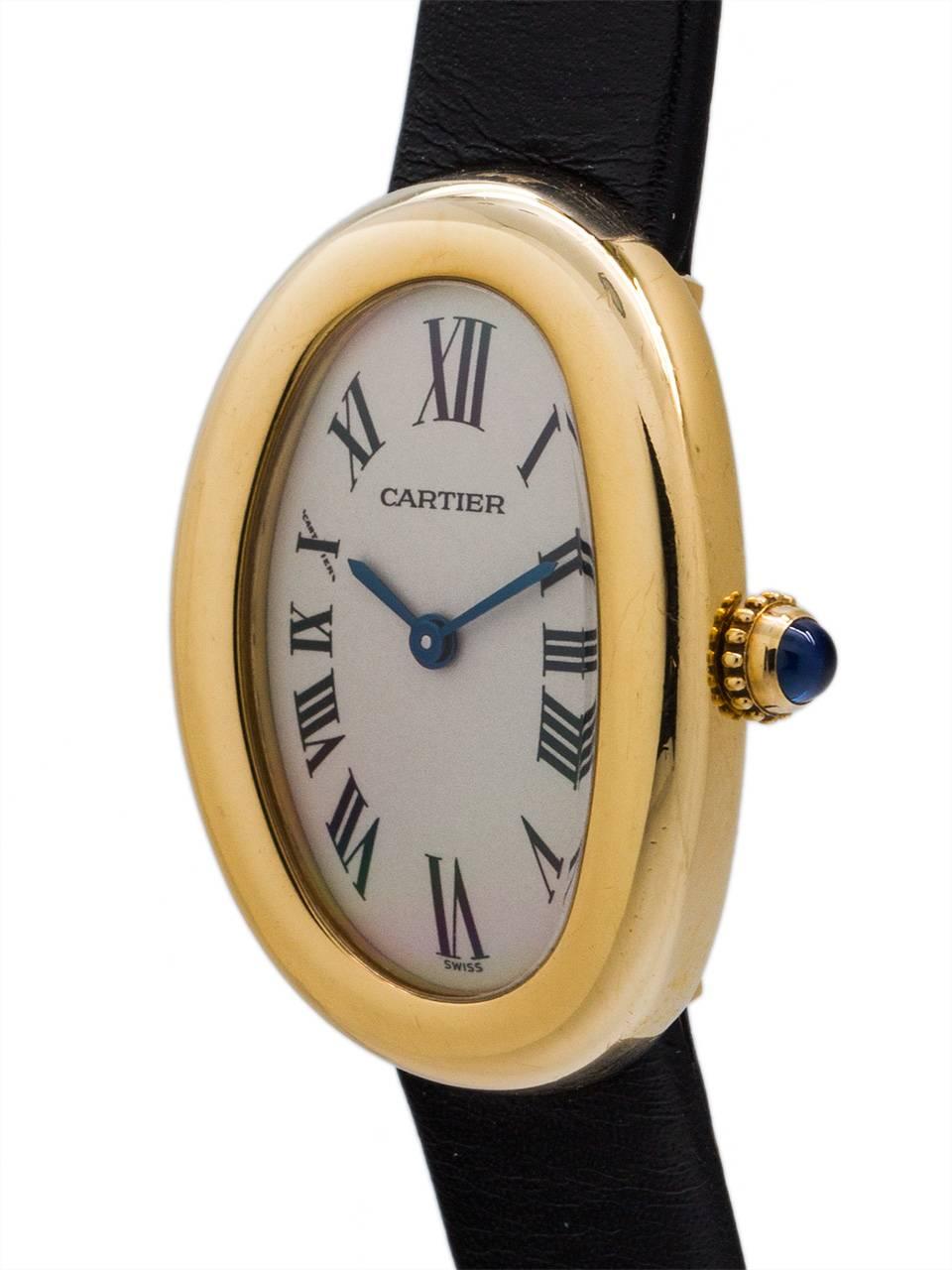 
Cartier 18K YG “Baignoire”  circa 1990’s. Featuring bathtub shaped 22 X 31mm curved back case secured by screws, with classic white Roman dial with blued steel hands and cabachon sapphire crown. Battery powered quartz movement.  With generic black
