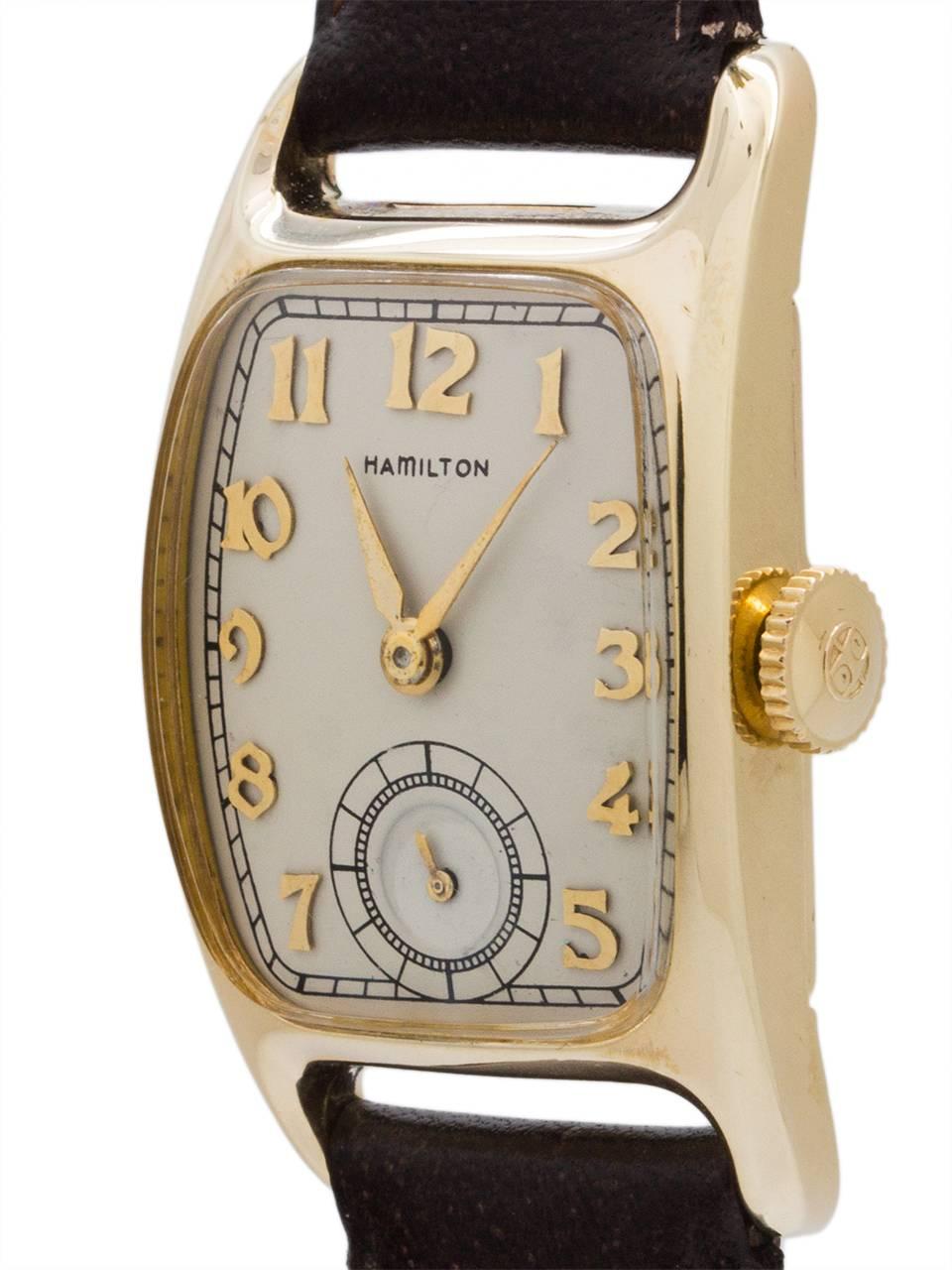 
Hamilton Yellow gold filled Boulton tonneau case classic model circa 1940’s, and the longest production model of all Hamilton wristwatches (1938-1951). Contoured tonneau shaped case, beautifully restored silvered satin dial with 18K gold applied