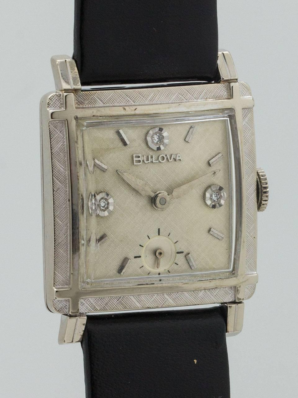 
Bulova Gent’s White Gold Filled  square picture frame style 26 X 35mm case with factory florentine finish bezel and matching florentine original silvered satin dial with diamond set indexes at 3, 9, and 12. Powered by 17 jewel manual wind movement