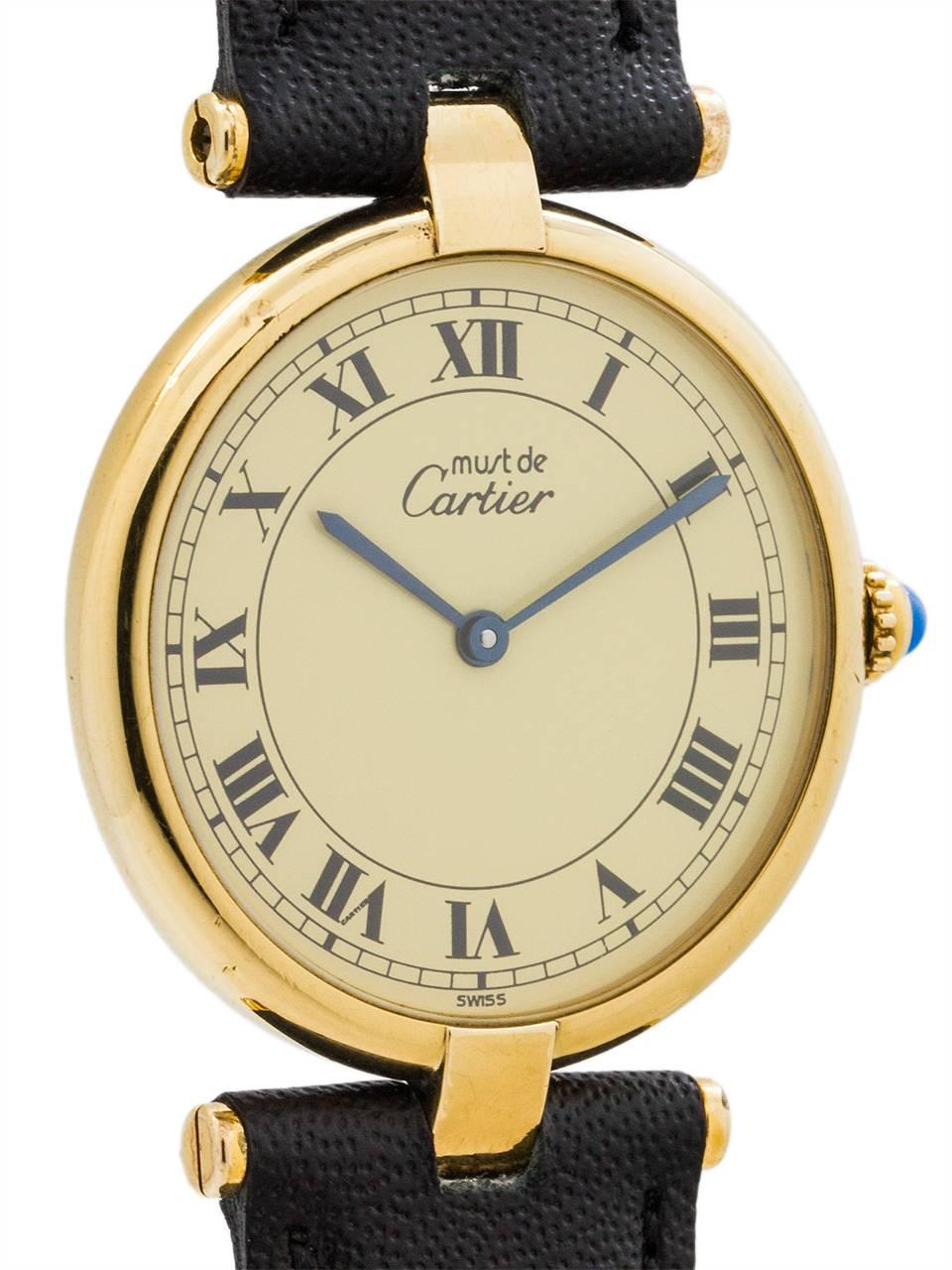 
Cartier Man’s Vermeil Vendome Tank Wristwatch circa 1990s. Case measuring 30.5 x 37mm with T-bar lugs. Featuring cream dial with classic printed Cartier Roman numbers with blued steel hands and blue sapphire cabochon crown. Battery powered quartz