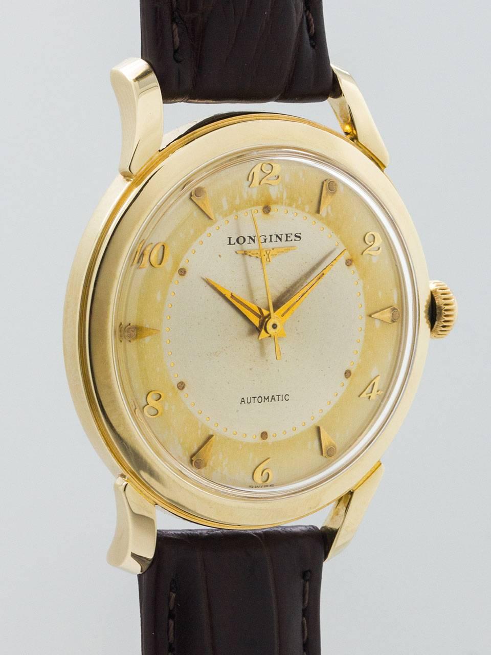 Longines Automatic 14K YG oversize 35 X 42mm screw back case with contoured and elongated lugs circa 1950’s. Unusually large for the era self winding model with acrylic crystal and original 2 tone patina’d dial with gold raised indexes  patina’d