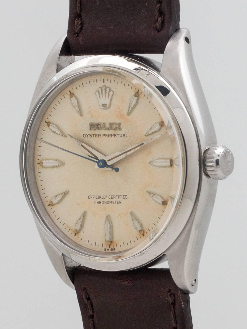
Rolex Oyster Perpetual ref 6564 stainless steel, case serial # 436,xxx circa 1959. Featuring 34mm diameter case with smooth bezel and very pleasing patina’d original dial with raised silver marquise shaped indexes, tapered dauphine hands and warmly
