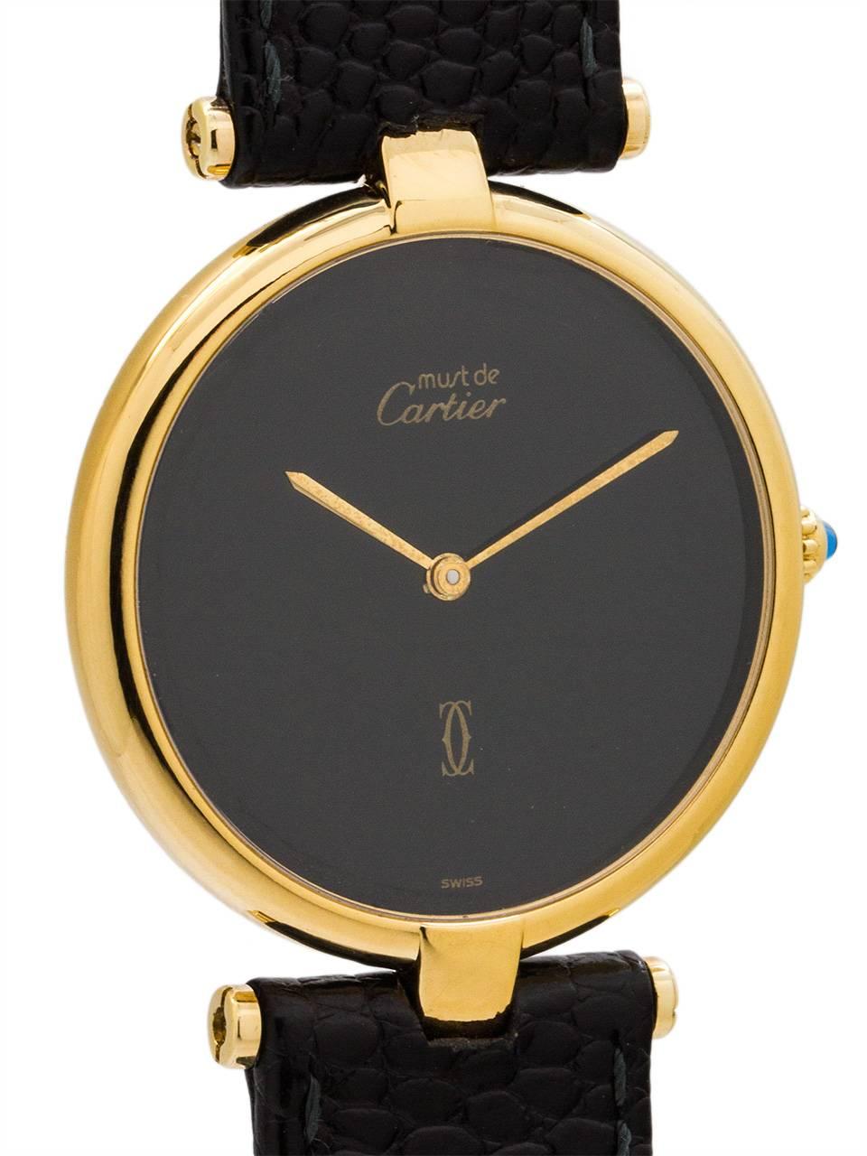 Cartier Lady’s Vermeil Vendome Tank wristwatch circa 1990s. Case measuring 30mm with t-bar lugs. Featuring a original black color dial with no hour or minute markers, and gold sword hands. Battery powered quartz movement with cabochon sapphire