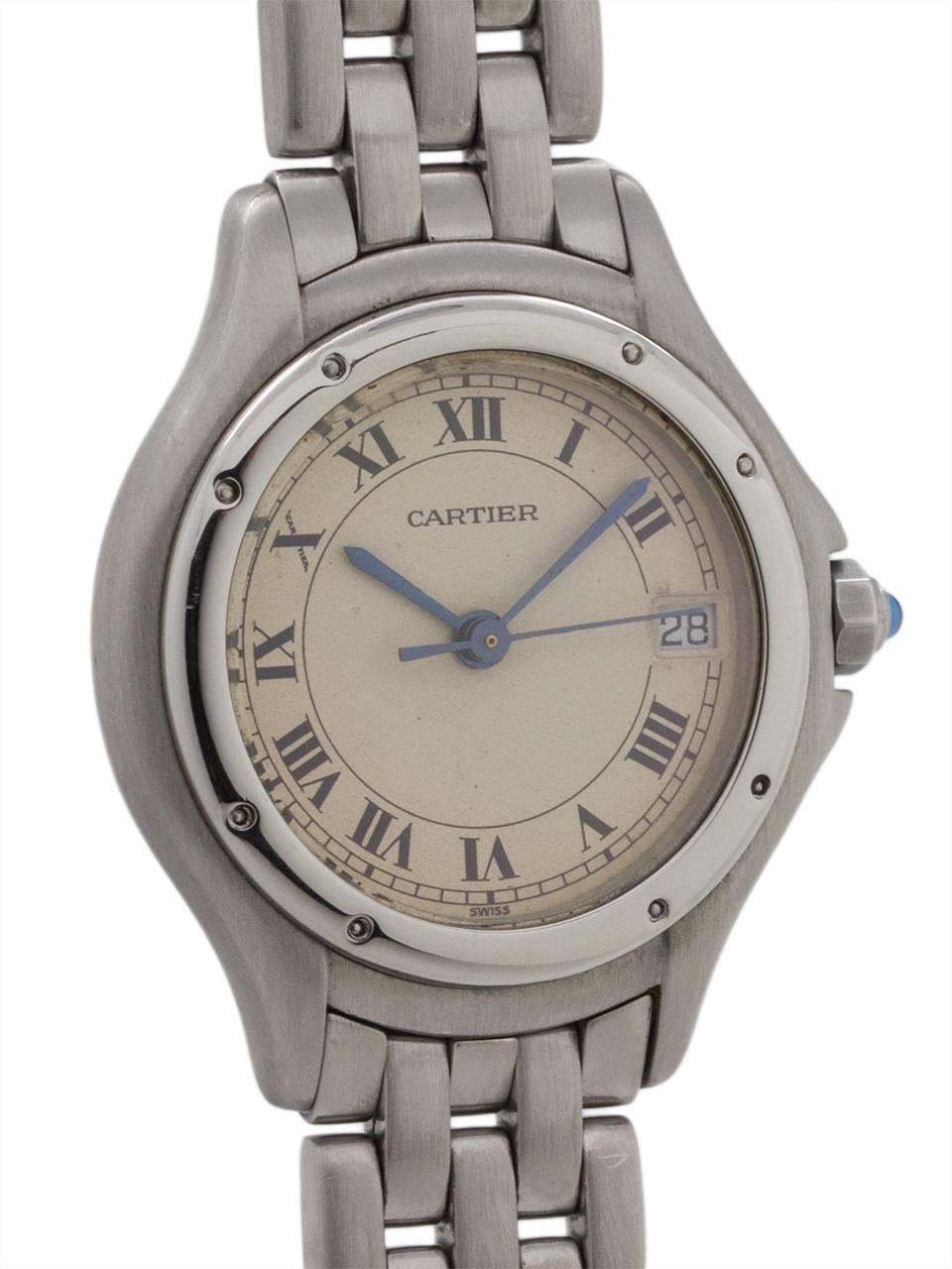 
Cartier lady’s Cougar model stainless steel circa 1980’s. Featuring round 27mm diameter case with rounded stepped bezel secured by screws, antique white dial with classic Cartier Roman figures and blued steel hands. Powered by quartz movement with