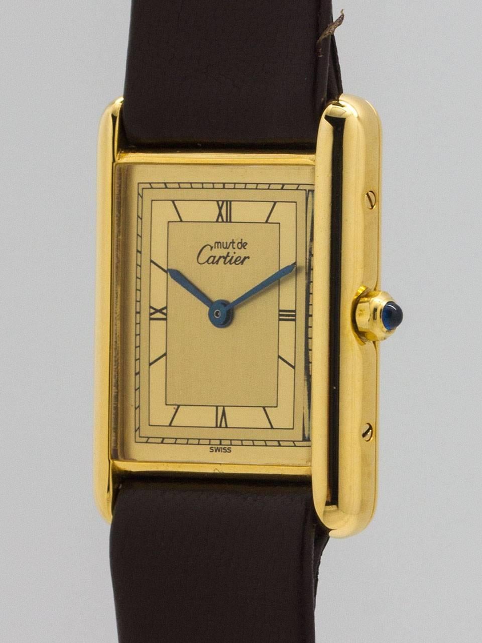 
Cartier Man’s Tank Louis vermeil (20 microns gold over silver) 26 X 31mm case secured by screws on side and back circa 2000. With unusual 2 tone cream dial with fine Roman figures and blued steel hands and blue sapphire cabachon crown. Battery