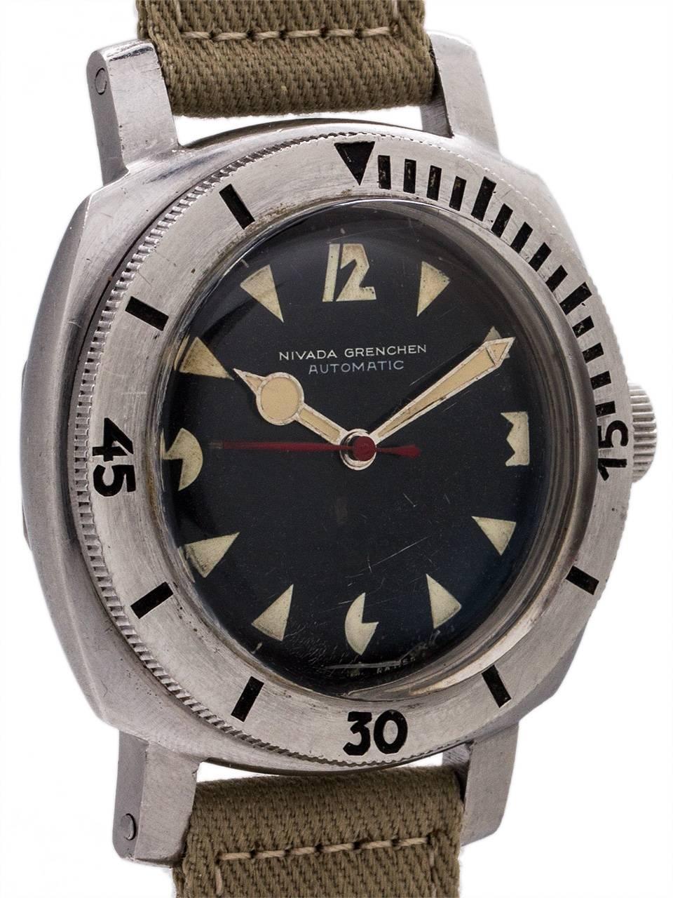 
Nivada Gretchen Depthmaster 1000, stainless steel cushion shaped diver’s model with heavy and rugged lugs, wide, raised elapsed time bezel, and with dramatic glossy black original dial with patina’d art deco inspired luminous indexes and hands and