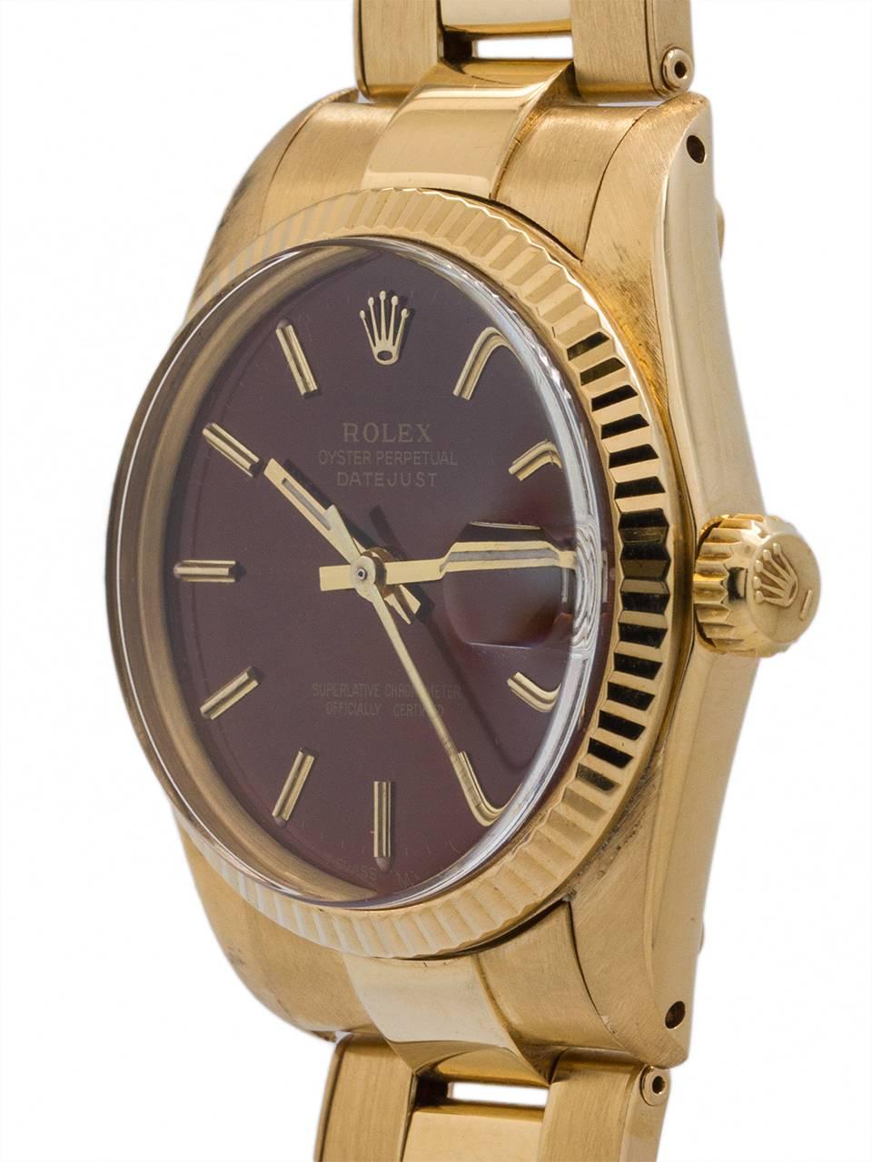 
Rolex midsize Datejust 18K YG ref 6827 circa 1982. Featuring 31mm diameter case with fluted bezel, acrylic crystal and custom root beer colored dial with applied gold indexes and gold baton hands. Powered by self winding movement with sweep seconds