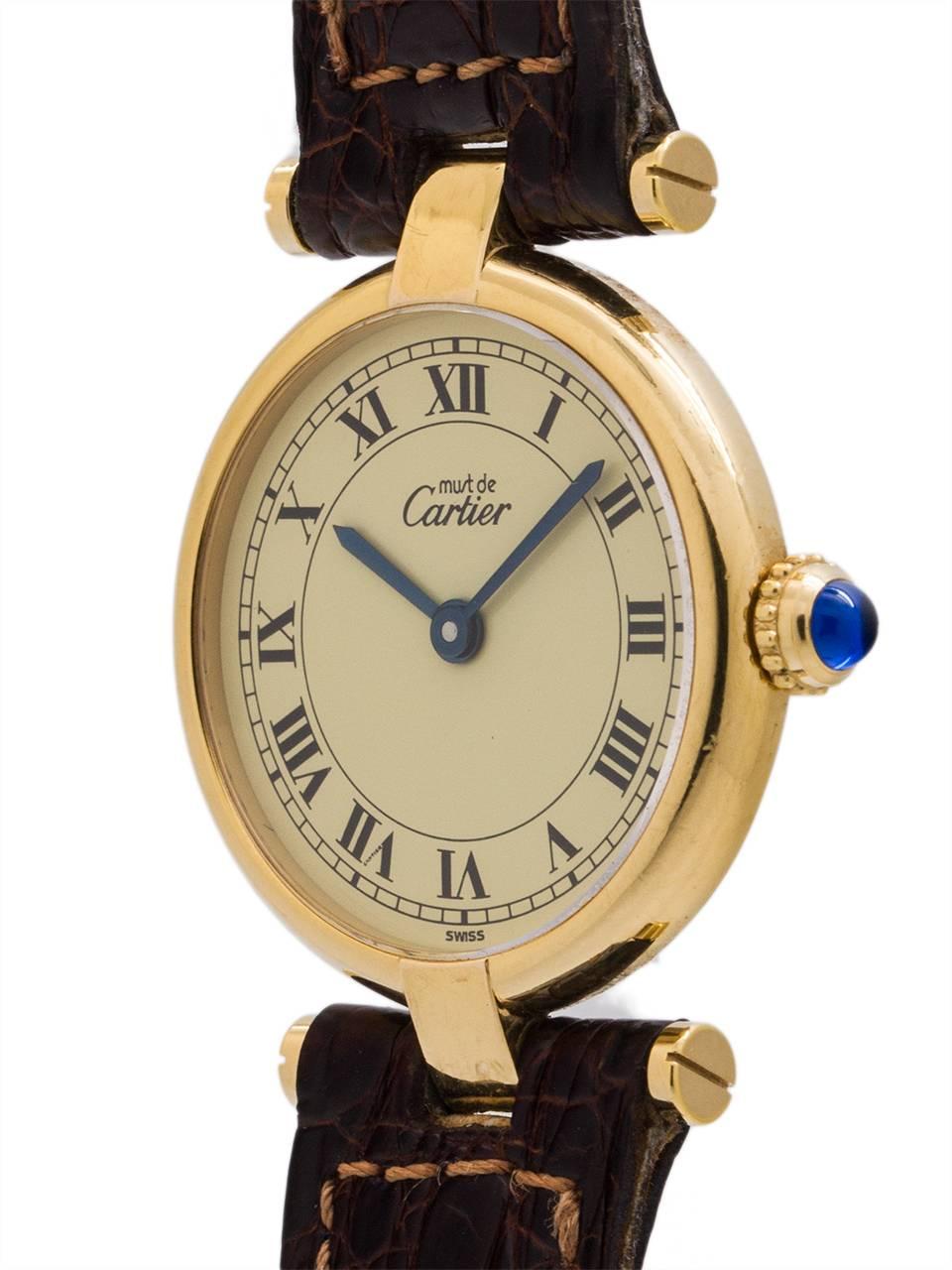 
Cartier Man’s Vermeil Vendome Tank Wristwatch circa 1990s. Case measuring 30.5 x 37mm with T-bar lugs. Featuring cream dial with classic printed Cartier Roman numbers with blued steel hands and blue sapphire cabochon crown. Battery powered quartz