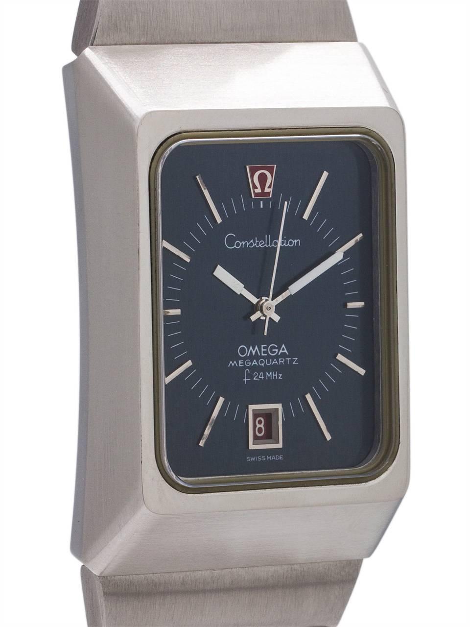 
Scarce and exceptional condition example circa 1970’s Omega Constellation Megaquartz 2.4MHz. Featuring a massive 32 x 49mm case 12mm deep with large metallic blue dial analog display with date window and “dead” sweep seconds hands. Massive vertical