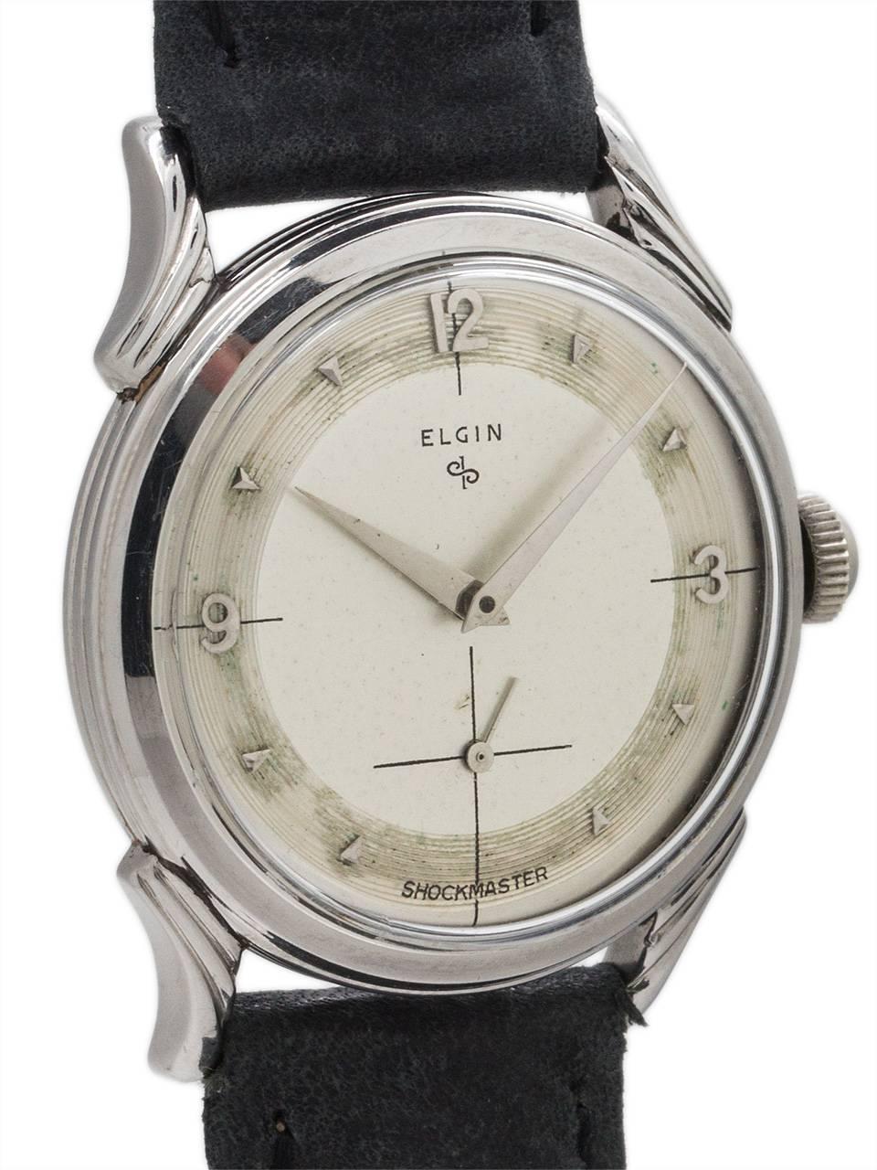 
Cool design vintage man’s Elgin manual wind “LP” dress model circa 1950’s. Featuring 32mm diameter screw back case with bowed and fluted lugs, acrylic crystal, and original 2 tone dial with applied indexes set against a finely grooved perimeter,