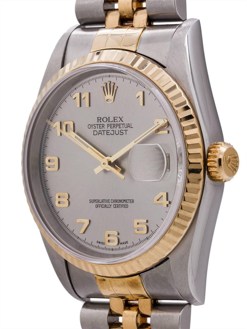 
Man’s Rolex Datejust ref 16233 stainless steel and 18K gold V serial# circa 1998. Featuring 36mm diameter case with 18K YG fluted bezel, sapphire crystal, and very popular original “Arabic Rhodium” dial with gray metallic background and bold gold