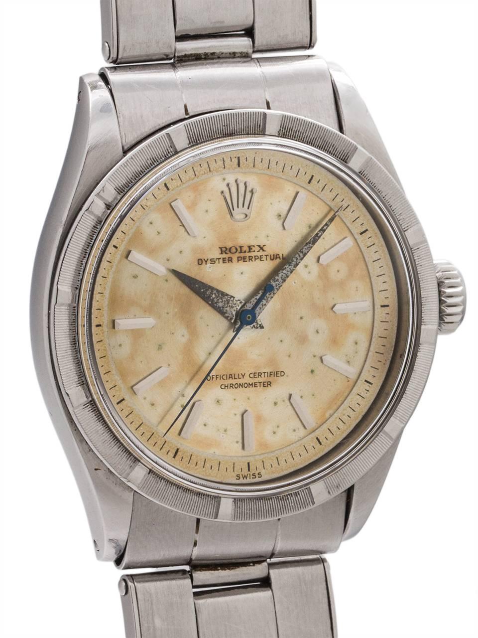 
Rolex Oyster Perpetual ref  stainless steel, case serial # 35,xxx circa 1953. Featuring 34mm diameter case with engine turned bezel and remarkable original richly patina’d stepped dial with raised silver  indexes, tapered dauphine hands and warmly