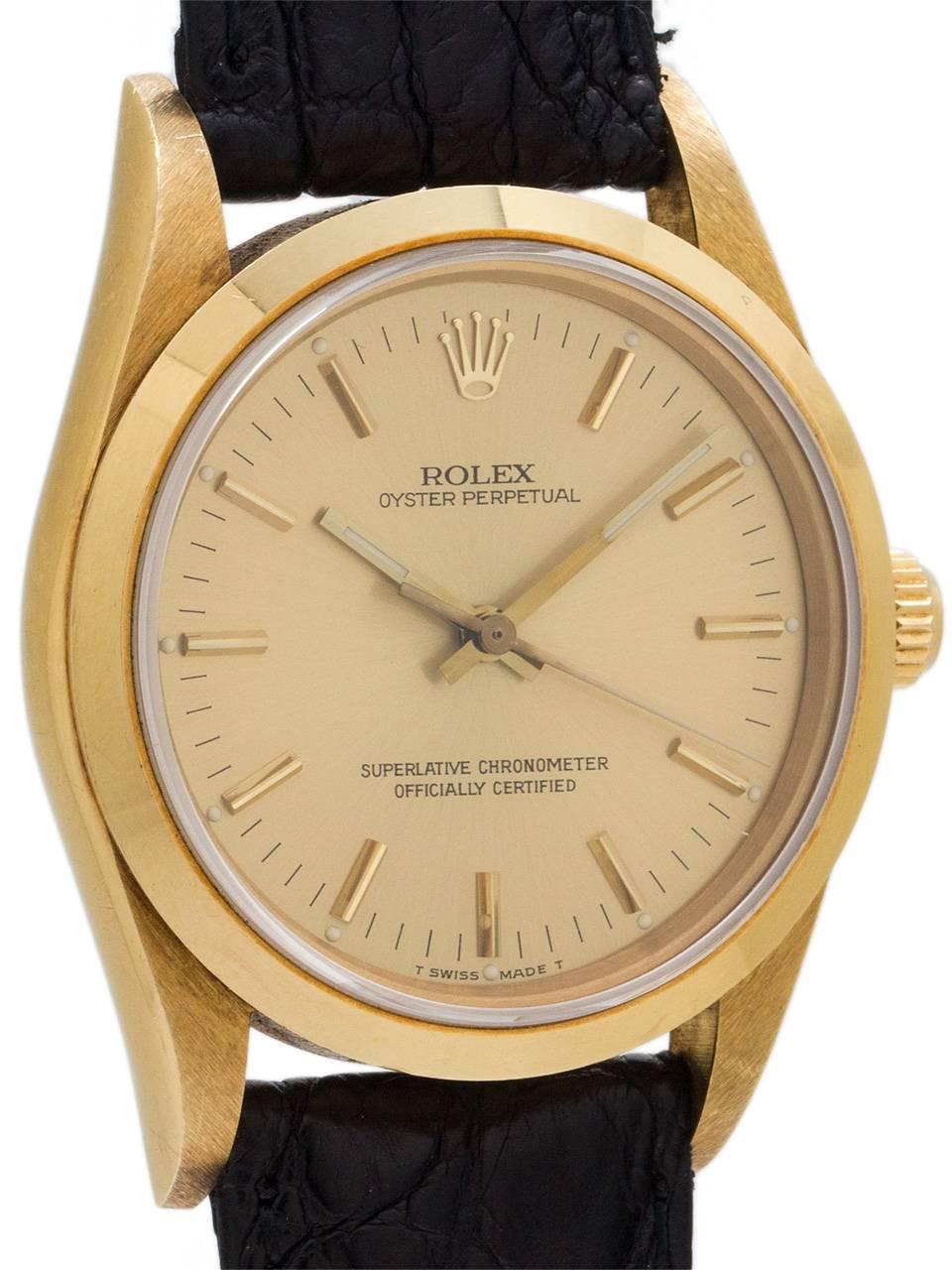 
Rolex Oyster Perpetual 18K YG ref 14208 circa 1988. Featuring 34mm diameter case with smooth bezel and sapphire crystal and original champagne dial with applied gold indexes and gilt baton hands. Powered by self winding calibre 3130 movement with