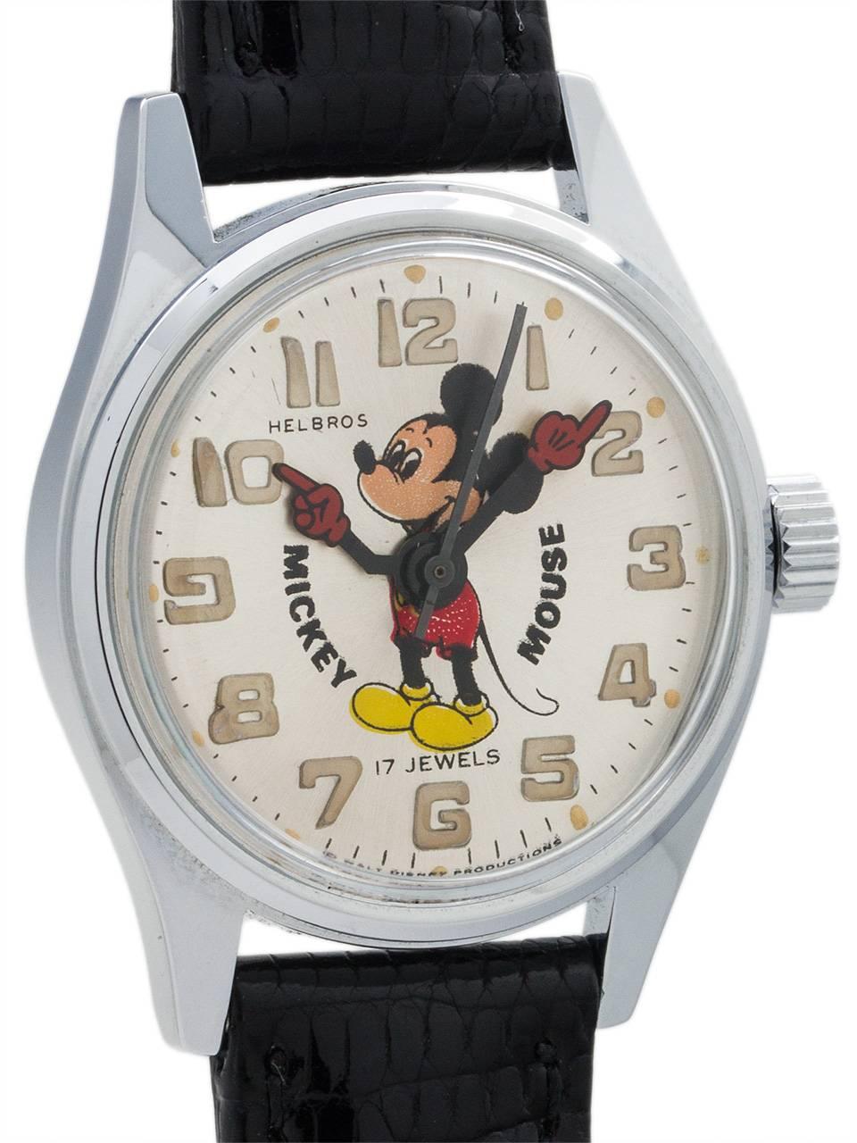 
Vintage medium size Helbros 17 jewel manual wind Mickey Mouse watch circa 1970’s. Featuring 31mm diameter chromium plated case with steel screw down back, with acrylic crystal, and with excellent condition original dial with polychrome depiction of