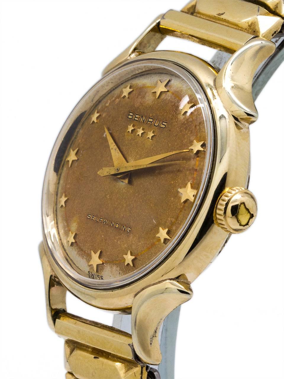 Benrus vintage gold-filled self winding man’s wristwatch circa 1959 with richly patina’d champagne dial with applied gold stars for the hour indexes and 3 additional stars applied below the name BENRUS. Featuring 32 x 39mm case with extended horn