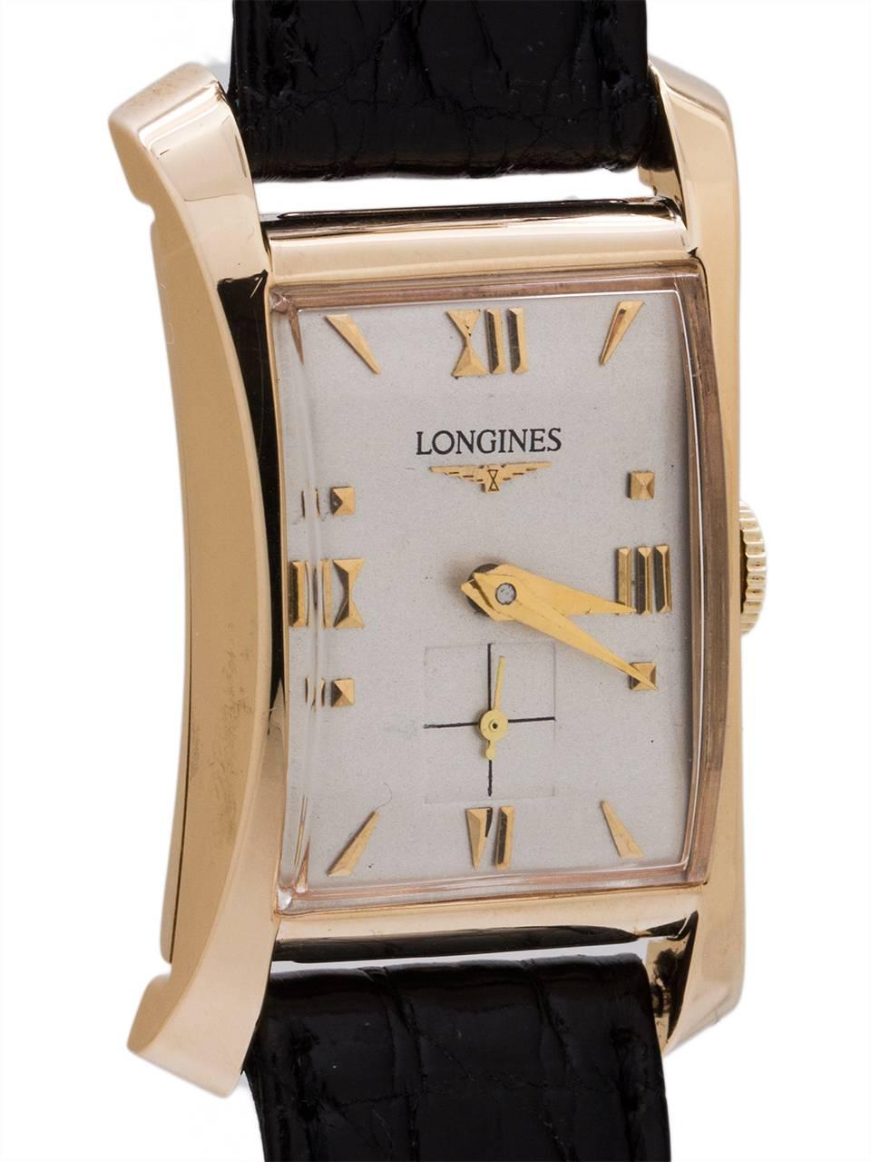 An especially stylish Longines 14K YG “moderne” Hourglass model 25 X 40 mm circa 1950’s. Stunning design model with great looking profile flared case, nicely restored silvered satin dial with gold applied indexes and tapered gilt hands. Note the 1/4
