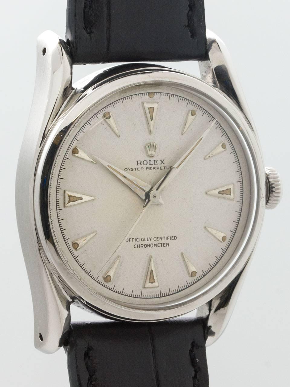 
Scarce and desirable model Rolex stainless steel “Bombe ref 5018 serial # 641,xxx circa 1948. Featuring 35mm diameter case with extended bowed lugs, smooth bezel, acrylic crystal, and very pleasing older refinished antique white dial with raised