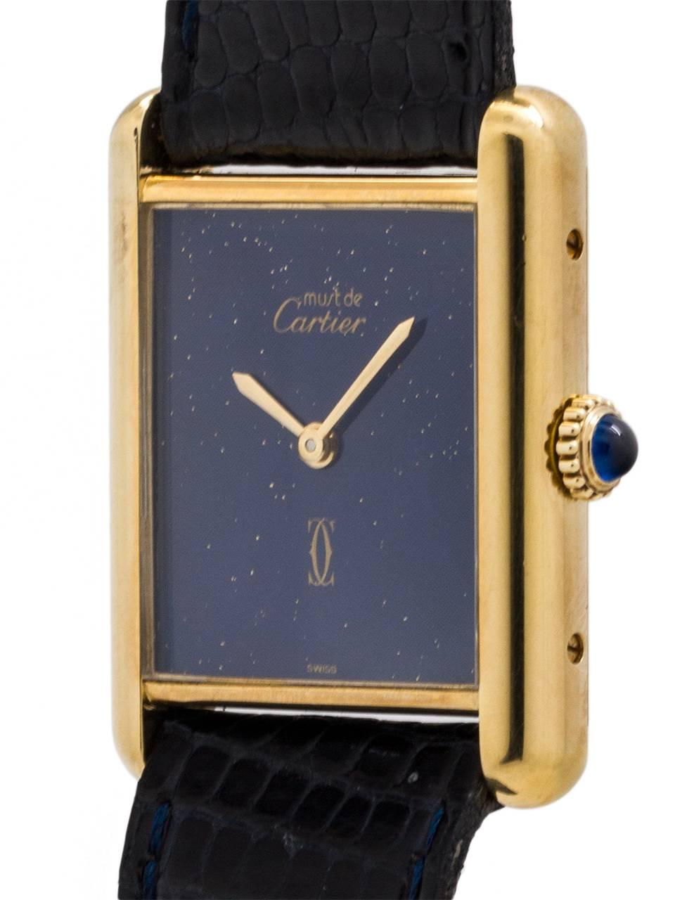 
Cartier Man's Tank Louis vermeil circa 1970s. 23.5 x 31mm case with mineral glass crystal and blue cabachon sapphire crown. With pleasing “faux” lapis blue dial signed Must de Cartier with double C logo and gold hands. Powered by 17 jewel manual