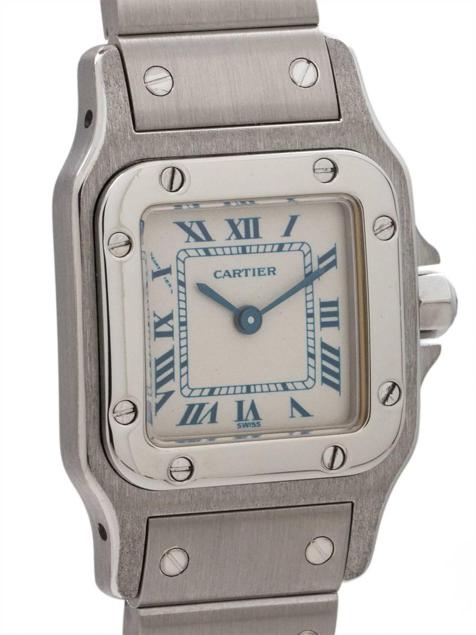 
Cartier Stainless Steel Santos circa 2000s. Square case measuring 24 x 35mm with round corner, screwed down bezel and cabachon sapphire crown. Classic Cartier white dial with blue Roman numerals and blue steeled hands. With battery powered quartz