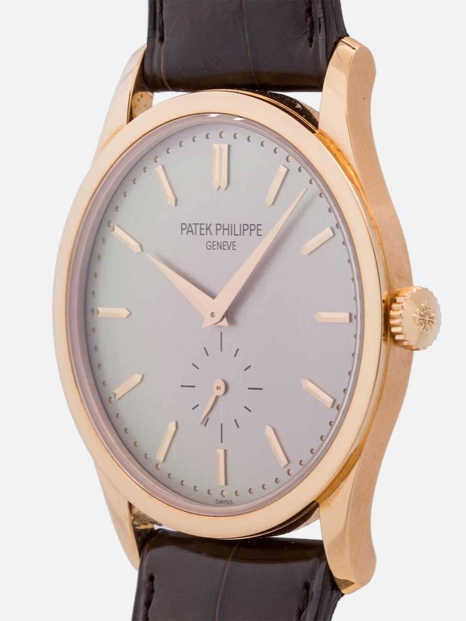 A very mint condition preowned classic Patek Philippe 18K rose gold large size Calatrava circa 2000s. Featuring a 37mm diameter case with classic 3 piece case construction, wide flat Calatrava bezel, and contoured lugs that extend from the body of