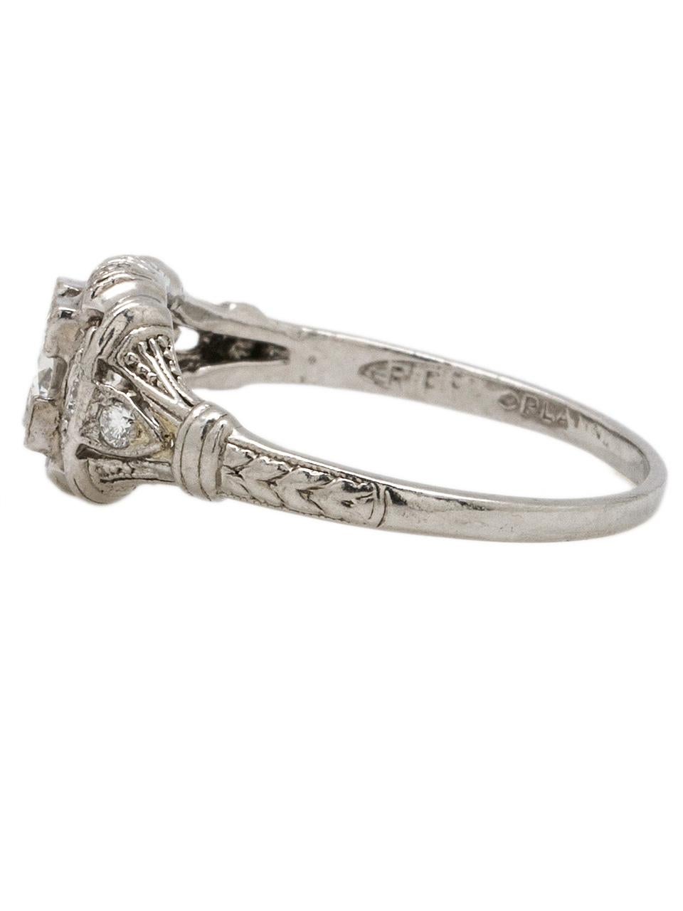 Beautiful vintage platinum diamond engagement ring with bright and lively 0.36ct Old European Cut center diamond with G color (near colorless) SI1 clarity . Fantastic, whimsical engraving and milgrain detail surround four round cut sides diamonds.