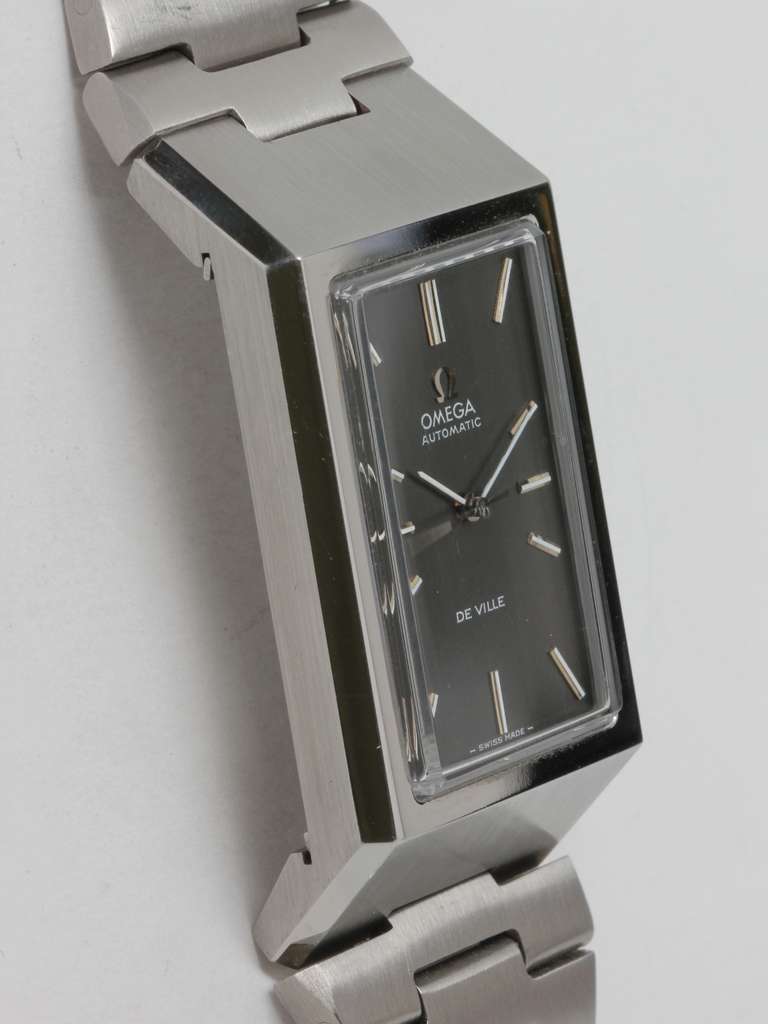 Omega stainless steel rectangular Deville Automatic wristwatch with bracelet, circa 1970s. Massive and thick rectangular case with beveled edges and sloped top and bottom, with mint condition original metallic gray dial with applied indexes and