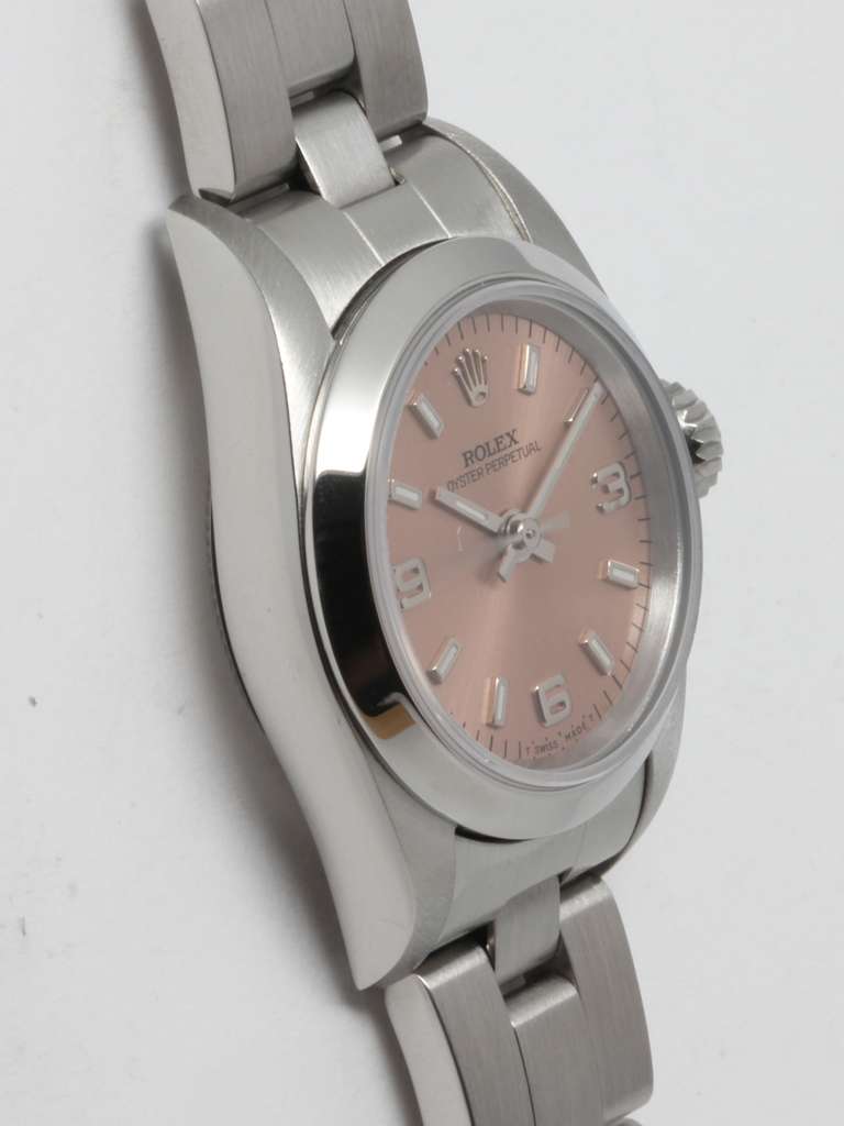 Rolex lady's stainless steel Oyster Pereptual wristwatch, circa 1996. 27mm case with smooth bezel, sapphire crystal and original salmon dial with applied figures, Arabic 3, 6, 9 and baton hands. Automatic movement with sweep seconds. With Rolex