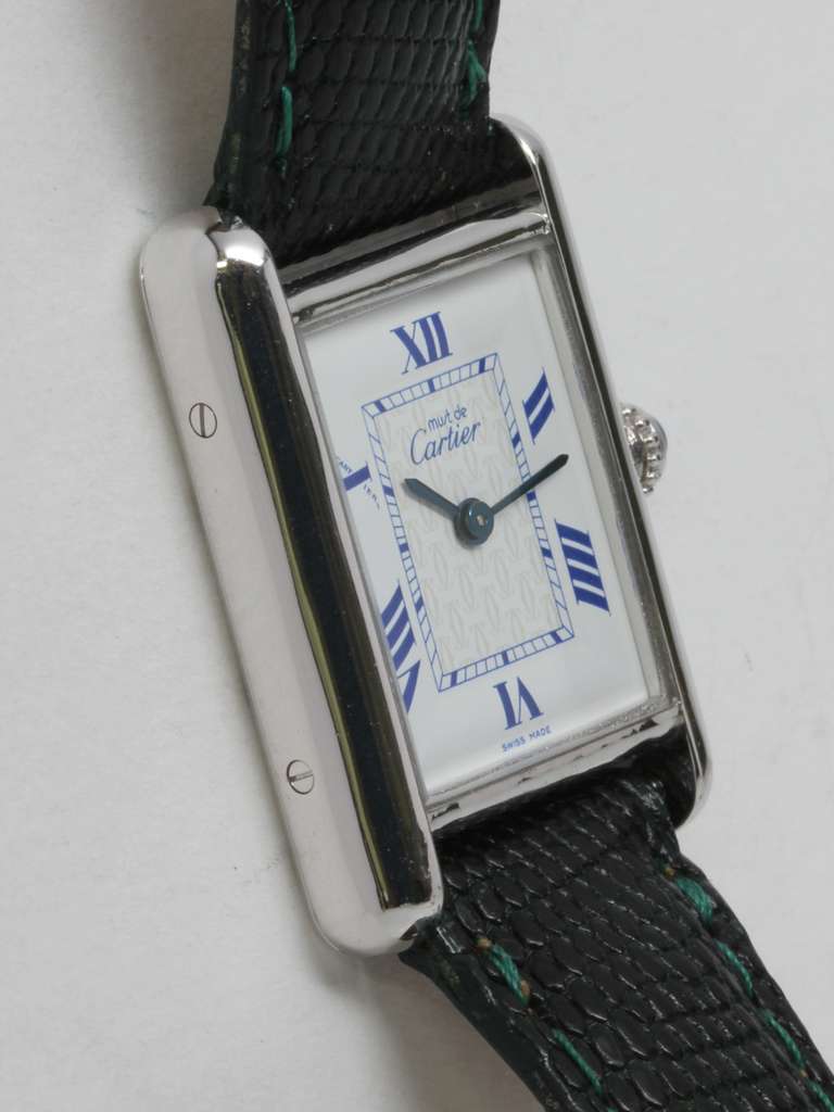 Must de Cartier sterling silver Must de Cartier Tank Louis wristwatch, newer water resistant-style case with eight screws securing case back, circa 2000. White dial with blue Roman numerals and printing, quartz movement with cabochon sapphire crown.