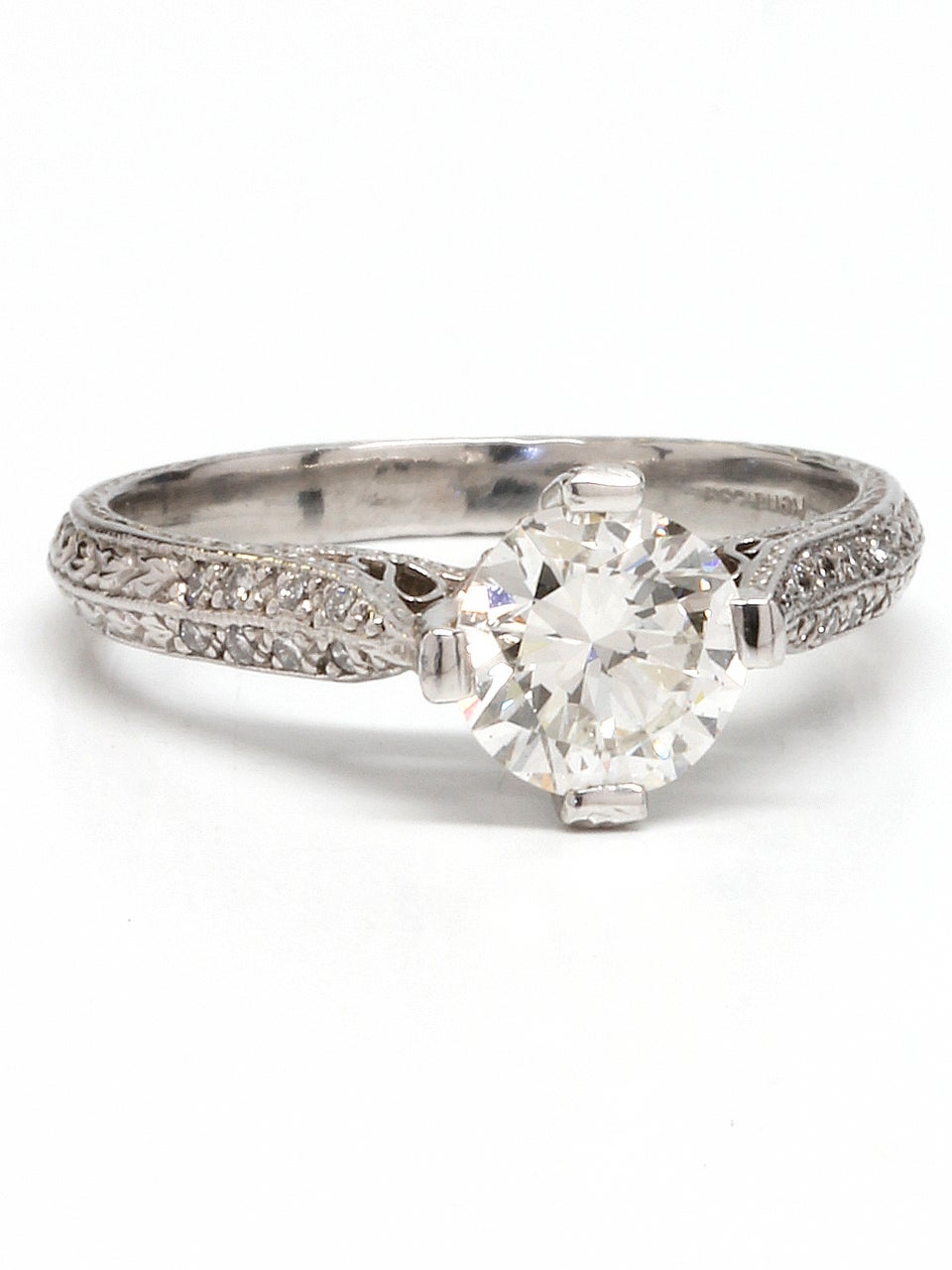 Stunning "New Vintage" 1920s inspired platinum engagement ring showcasing an EGL certified 1.05ct Transitional round cut center diamond, H-VS1. Two rows of pave diamonds adorn the shank, with diamonds even set up around the elevated center