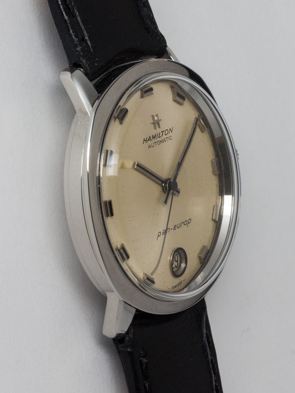 Hamilton Stainless Steel Pan-Europ Wristwatch circa 1960s. 34 X 36mm round case with wide bezel and acrylic crystal. With original silvered satin dial with square indexes and hands, port hole style date window at 6 o'clock, and signed Hamilton