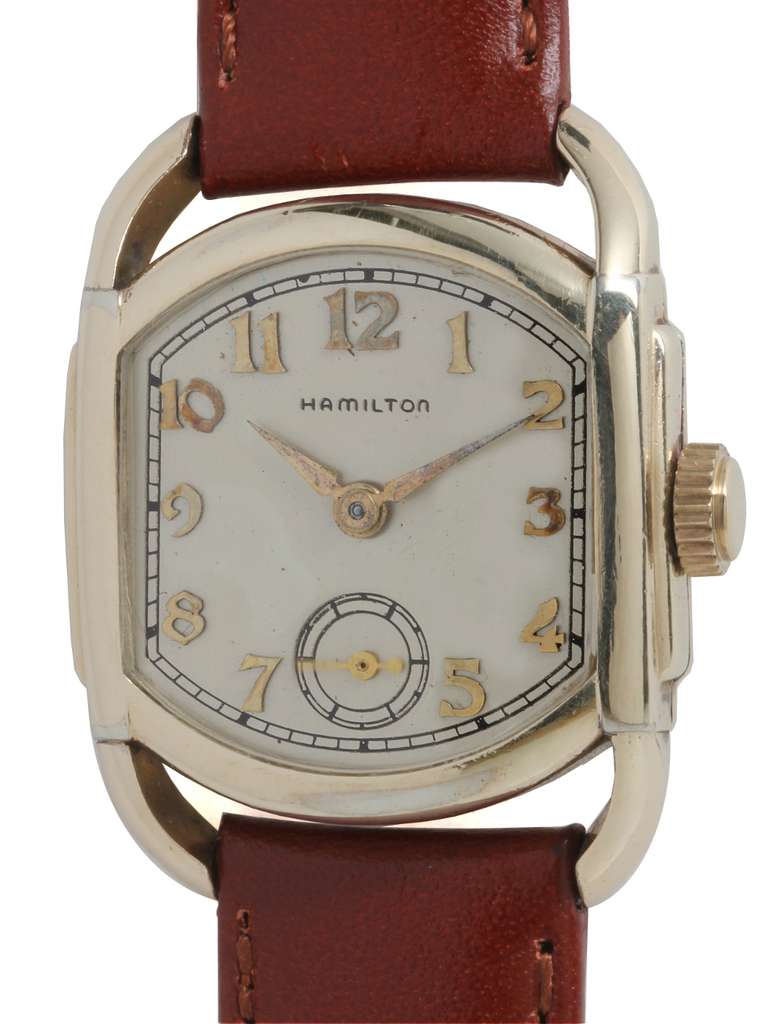 Hamilton gold filled Bagley model wristwatch, circa 1939. Cushion case, 27 X 33mm, with curved lugs. Original matte silvered dial with applied Arabic numerals. 17-jewel manual-wind movement with subsidiary seconds. Original crown. On your choice of