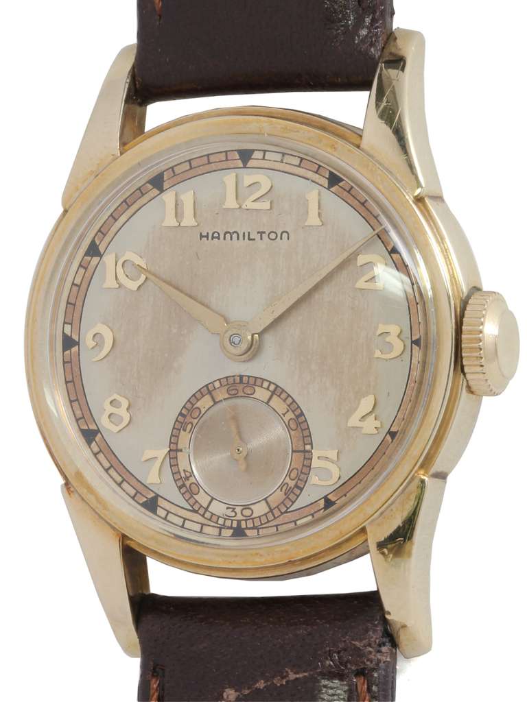 Hamilton gold filled Endicott model wristwatch, circa 1941. Classic round 29 X 38mm case with wide bezel and large extended lugs. With very pleasing patinaed silvered dial with applied Arabic numerals and alpha hands. Powered by a 17-jewel