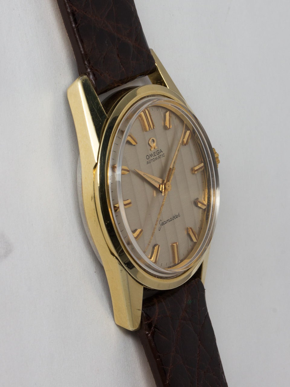 Omega Seamaster Automatic Wristwatch, ref 14700.1 SC movement serial # 18 million circa 1961. 33.5 x 43mm gold shell top case with stainless steel back with Seamaster logo and signed Omega crown. Original ribbed textured silvered dial with applied