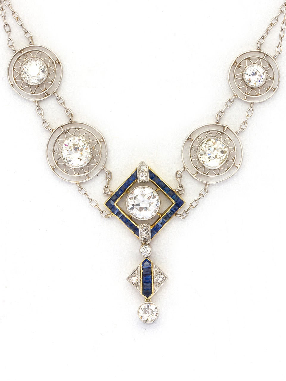 Absolutely stunning Art Deco Diamond necklace made of platinum over 18K yellow gold with over 3.50cts old European cut bezel set diamonds,VS1-VS2/G-H, in sunburst pattern plaques. Center diamond and drop are accented with calibrated French cut