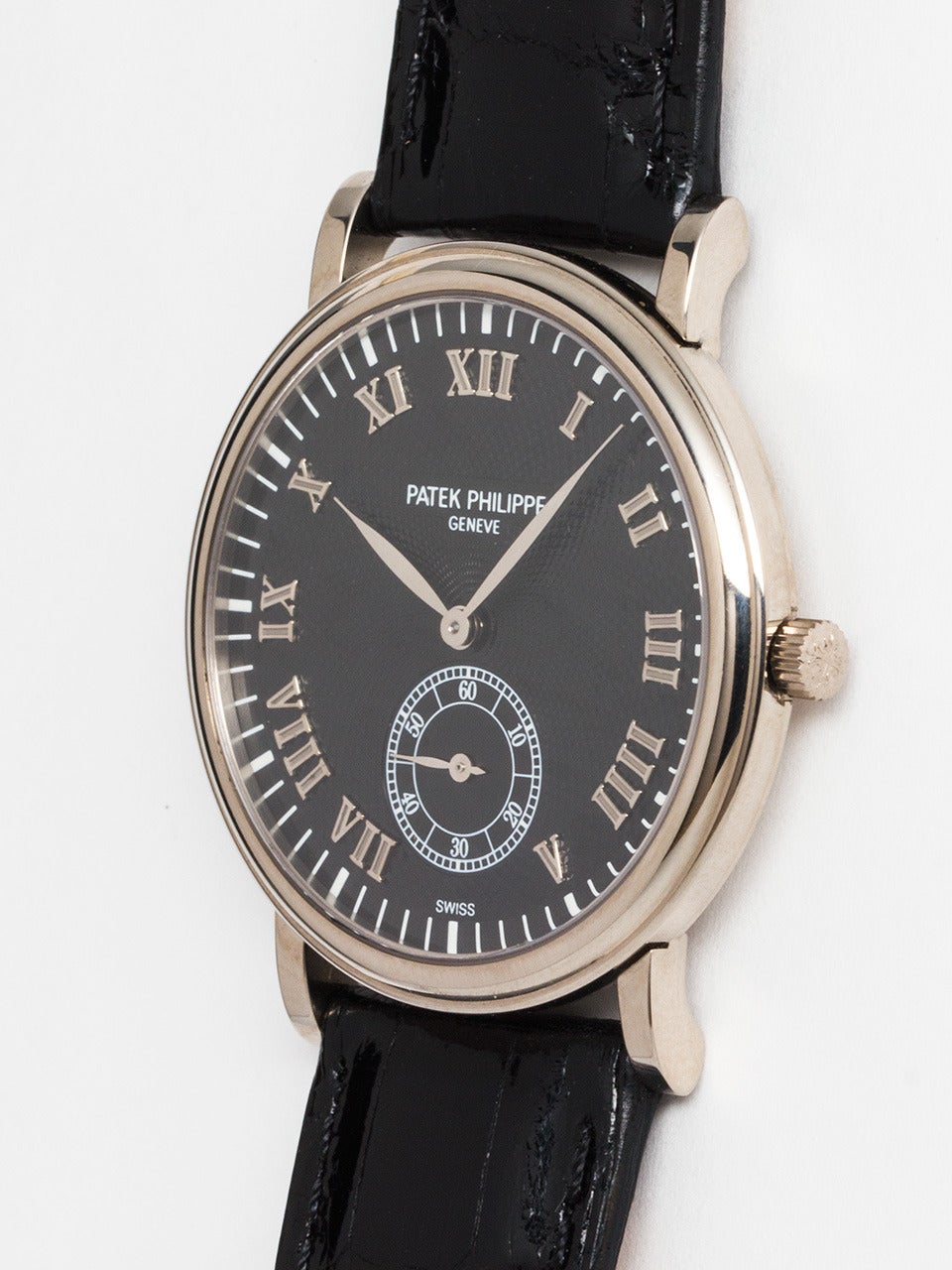 Patek Philippe 18K WG ref 5022G circa 1990's. Classic Calatrava model featuring 33mm diameter case, hobnail bezel, signed PP & Co crown. Beautiful black waffle dial with contrasting outer track and large sub seconds and raised plaque bearing PP &