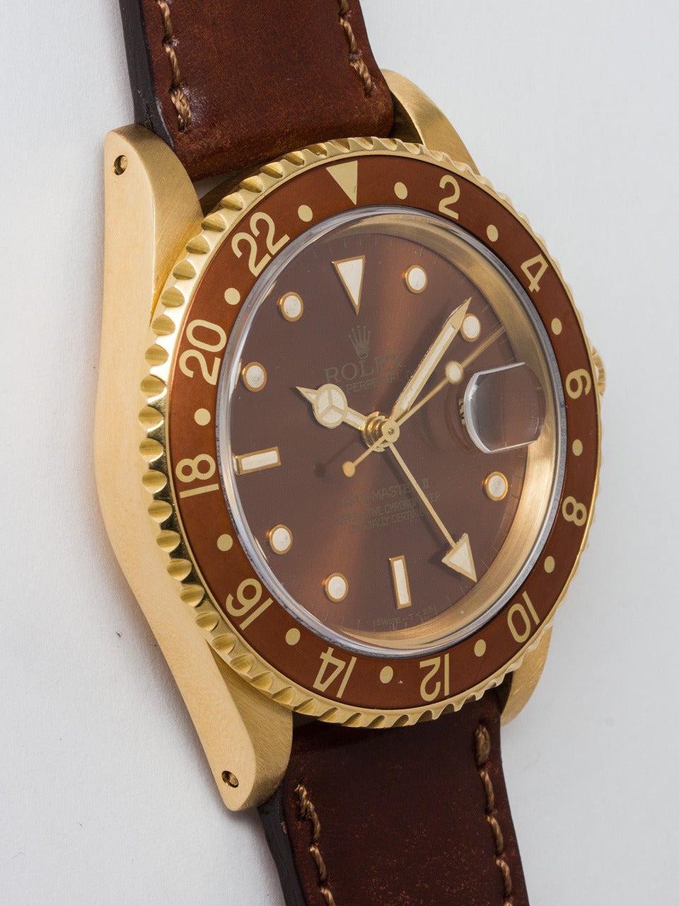Rolex 18K Yellow Gold GMT-Master II Wristwatch, ref 16718 serial number L2 circa 1988. 40mm Oyster case with bronze 24 hour bezel and sapphire crystal. Lovely root beer dial with tritium markers and hands. Powered self winding movement with