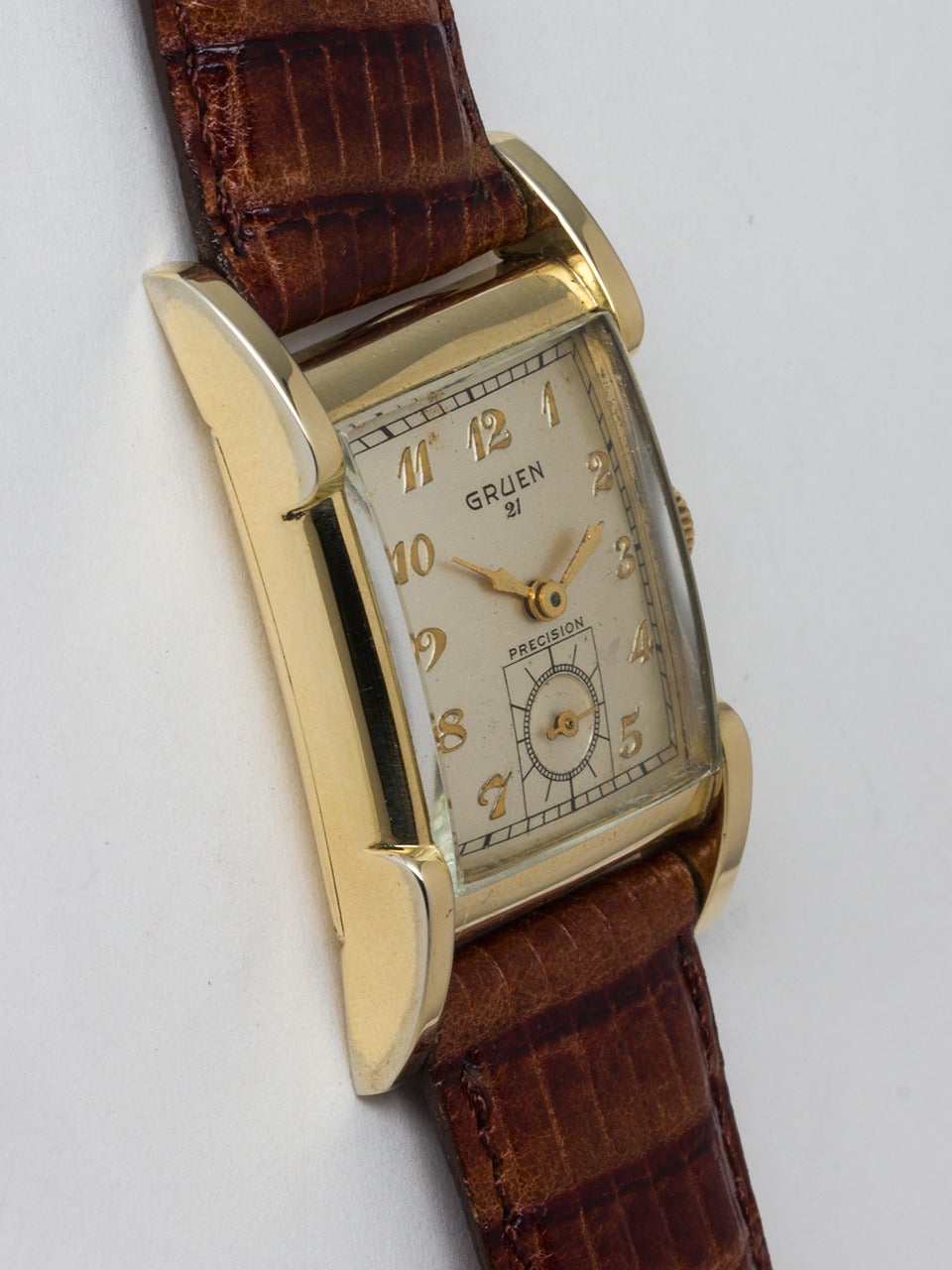 Gruen Yellow Gold Filled 21 Precision Wristwatch circa 1940s. Case measuring 23.5 X 37.5mm with extended lugs. Original silver satin dial with raised Arabic figures and gilt leaf style hands. Powered by 17 jewel manual wind movement with subsidiary
