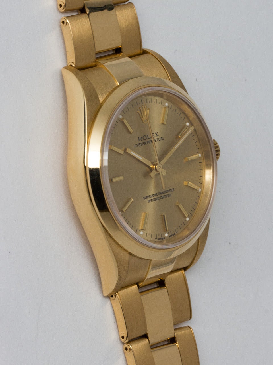Rolex 18K Yellow Gold Oyster Perpetual Wristwatch ref 14208 serial number U4 circa 1997. 34mm diameter case with smooth bezel and sapphire crystal. Original champagne dial with applied gold indexes and gold baton hands. Powered by self winding